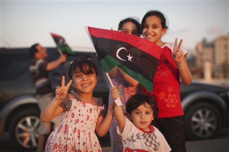 Bashir Khamis, 2, front, poses for a photo together with his sisters at seaside of the rebel-held town of Benghazi, Libya, on Monday.